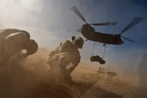Helicopters Prints: Soldiers in the dust of a Chinook helicopter hauling a Humvee at Nellis Air Force Base Nevada