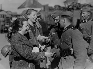 Austria Prints: Soldiers receive gifts from Austrian women after the Anschluss, 1938. (BSLOC_2013_9_187)