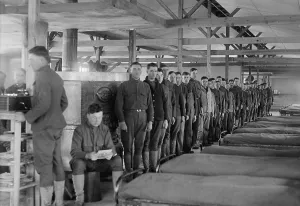 Crowded Prints: Soldiers stand in a row by their beds in the barracks at Camp Mead