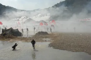 South Korea Prints: South Korean soldiers dressed as North Korean infantry charge South Korean defenses at the re-enactment of the Nakdong