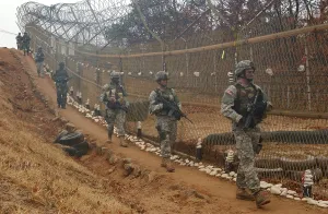 Barrier Prints: South Korean and US Soldiers patrol long a fence at the United Nations Security Area in Panmunjom during an annual
