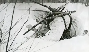 Lcgr1406 Prints: Soviet (Russian) World War 2 medic collects rifles from as he treats soldiers in battle