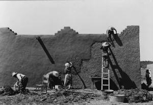 Construction Prints: Spanish-American women engaged in the yearly re-plastering an adobe house in Adobe