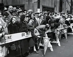 Celebration Prints: Spectators lean over barricades to watch the approaching St
