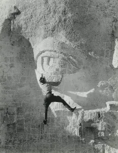 Granite Prints: Staged photo of worker hanging from Jefferson's eye lid on Mount Rushmore
