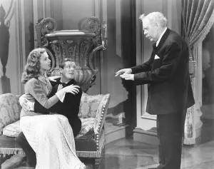Sitting On Lap Prints: IT STARTED WITH EVE, from left: Deanna Durbin, Robert Cummings, Charles Laughton, 1941