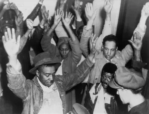 Columbia Prints: State highway patrolmen search group of Negroes arrested during rioting on Feb. 26, 1946