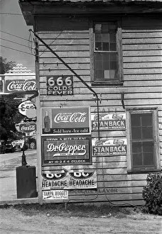Coca Cola Prints: Side of a store, showing advertising signs