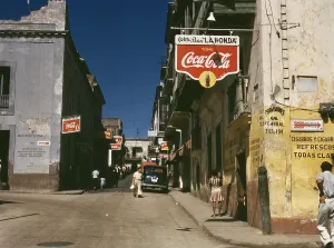 December Prints: Street in San Juan Puerto Rico where many business advertise with Coca Cola signs