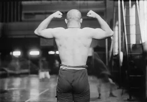Muscles Prints: Strong man flexing muscles, Yussif Mahmout, photograph, circa 1900s-1920s
