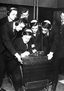 Recruitment Prints: Student transmitting a message to four of his classmates in a radio class at the Stuyvesant Evening High School