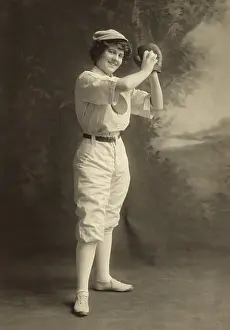 Pitching Prints: Studio portrait of a smiling young woman in pitching stance