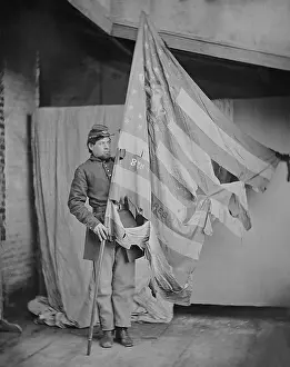 Studio Portrait Prints: Studio portrait of a Union soldier with the tattered battle flag of the 8th Pennsylvania Volunteers