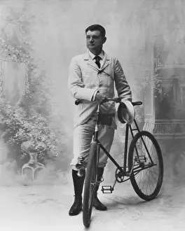 Bicycle Prints: Studio portrait of young man and his bicycle, c. 1895