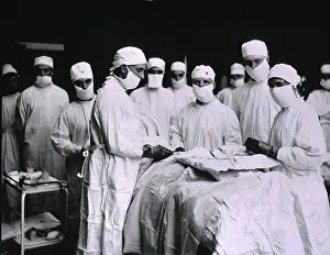 Physicians Prints: Surgeons and nurses masked in preparation for surgery at U