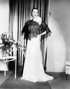 1930s Fashion Prints: Sylvia Sidney in gown and cape designed by Howard Greer, 1935