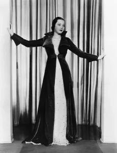 1930s Fashion Prints: Sylvia Sidney in ruby velvet wrap over white orggandy evening gown, 1935