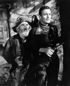 Gabby Prints: TALL IN THE SADDLE, from left, George Gabby Hayes, John Wayne, 1944