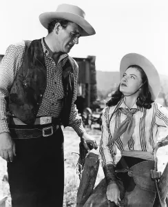 Raines Prints: TALL IN THE SADDLE, from left, John Wayne, Ella Raines, 1944