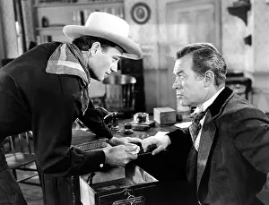 Bond Prints: TALL IN THE SADDLE, from left, John Wayne, Ward Bond, 1944