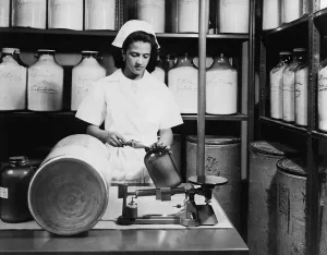 Mexicans Prints: Technician fills brown glass jar with hormones derived from wild poisonous yam