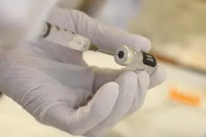 Medicine Prints: A technician loads a syringe with COVID-19 vaccine at Walter Reed National Military Medical Center in Bethesda