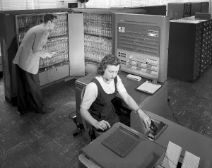 Electronics Prints: Technicians working with room size IBM type 704 computer making calculations for aeronautical research