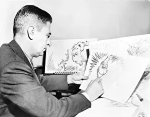 Cartoonist Prints: Ted Geisel (Dr. Seuss) (1904-1991) at work on a drawing of the Grinch