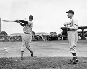 Batting Prints: Ted Williams gets batting practice by hitting grapefruits pitched by Red Xox Manager Joe Cronin
