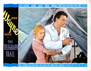 Wayne Prints: THE TELEGRAPH TRAIL, US lobbycard, from left: Marceline Day, John Wayne, 1933