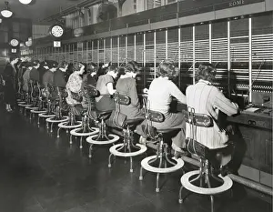 Operators Prints: Telephone operators working on an international switchboard in the 1930s