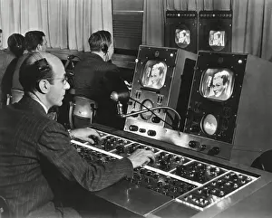 Electronics Prints: Television studio engineer gets several views of the image and use the complicated set of dials to control the tone
