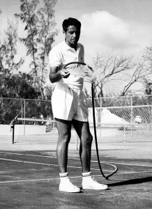 Tennis Court Prints: Tennis player Pancho Gonzales hosing off his courts in the Bahamas
