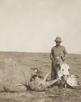 Shot Prints: Theodore Roosevelt holding a dead bustard and standing next to a dead rhinoceros