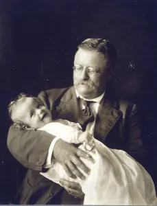 First Families Prints: Theodore Roosevelt smiling as he holds his grandchild, Kermit Roosevelt, Jr. 1916 photo
