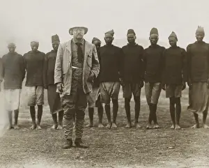 Contrast Prints: Theodore Roosevelt standing in front of African men working for his safari