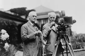 Edison Prints: Thomas Edison 1847-1931 and George Eastman 1854-1932 standing with motion picture camera ca