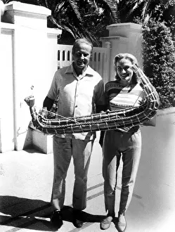 Explorer Prints: THOR HEYERDAHL and wife Yvonne Heyerdahl hold model of 'Ra'