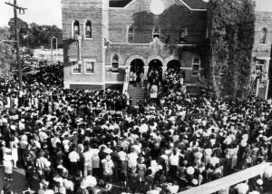 Images Dated 3rd March 2007: Thousands of people crowd around the church where the funeral of three of the four girls killed in a church bombing is
