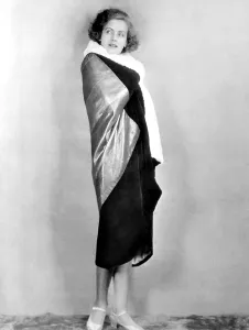 Evening Coat Prints: TORRENT, Greta Garbo, modeling an evening wrap gold metal cloth and black velvet, 1926