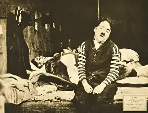 Sitting On Bed Prints: TRIPLE TROUBLE, foreground: Charlie Chaplin, lobbycard, 1918