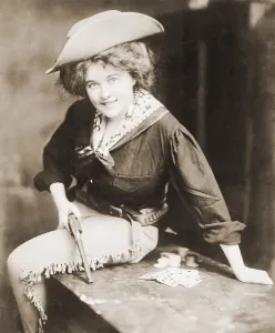 Revolvers Prints: Turn of the century Cowgirl holding revolver