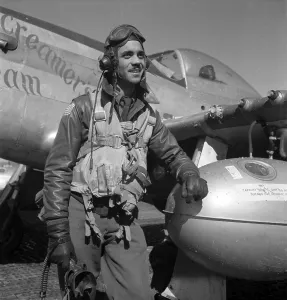 Flight Suit Prints: A Tuskegee fighter pilot poses with his P-51D Mustang