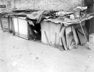Economic Crisis Prints: An unemployed man living in a shack constructed from packing cases and pieces of wood in New York City