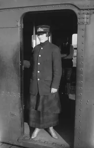 Brooklyn Prints: Uniformed woman Brooklyn Subway guard stands in the doorway of train car. Ca. 1910