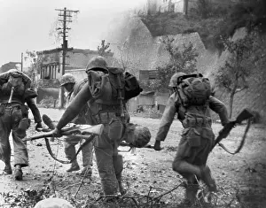 Litters Prints: United Nations forces carry a soldier wounded in the street fighting to an aid station