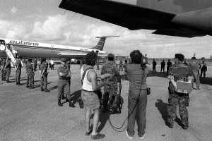 Proxy Wars Prints: U.S. Air Force security police guard Cuban nationals as they board the airliner returning them to Cuba