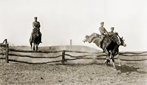 Jumping Prints: Three U.S. Army cavalrymen exhibit their horsemanship as they jump over barrier fences at a full gallop
