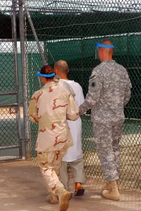 Candid Occupational Portraits Prints: U.S. Army and Navy guards escort a detainee to Guantanamo Bay's Camp One recreational area where he could spend up