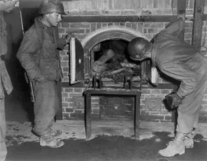 Mass Murder Prints: Three U.S. Army soldiers looking at bodies in oven of an unidentified German concentration camp